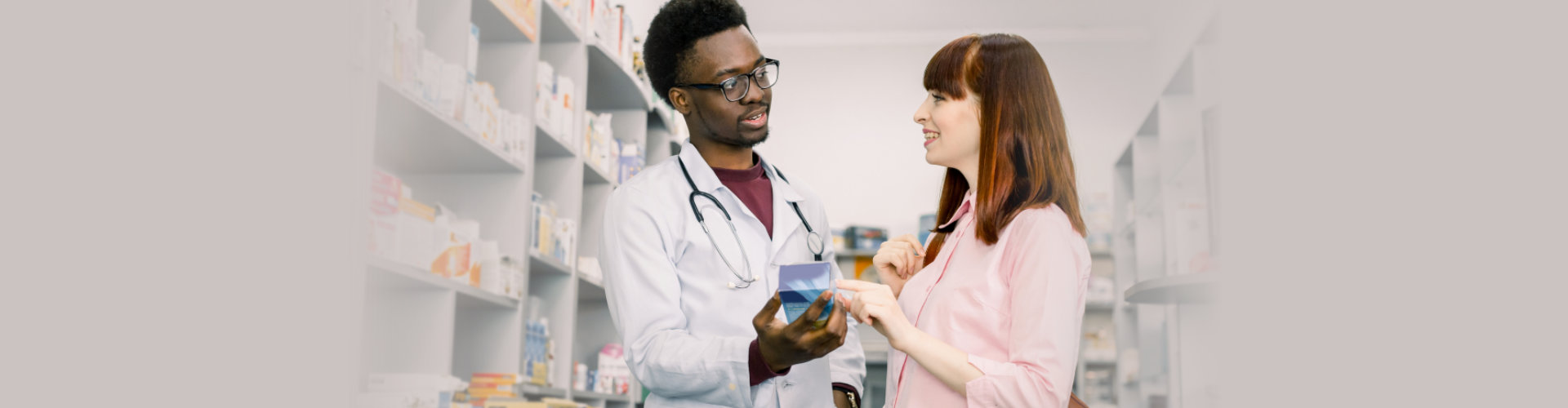 African male pharmacist talking with a beautiful female