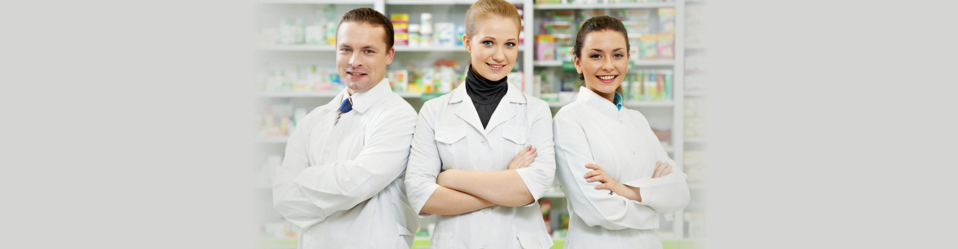 Cheerful pharmacist chemist women standing in pharmacy drugstore
